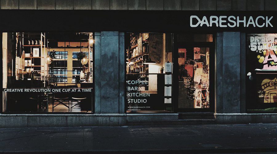 The Dareshack shopfront in Bristol, with lit windows beneath its sign