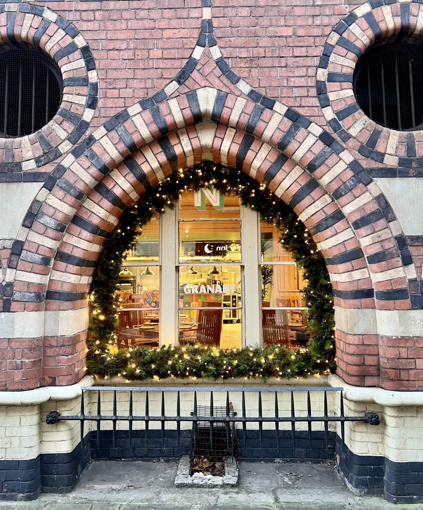 The Granary arched brick window on Welsh Back framed with a Christmas wreath and lights